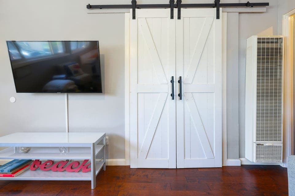 Barn Door that houses all in one washer/dryer, beach chairs, etc. in living room
