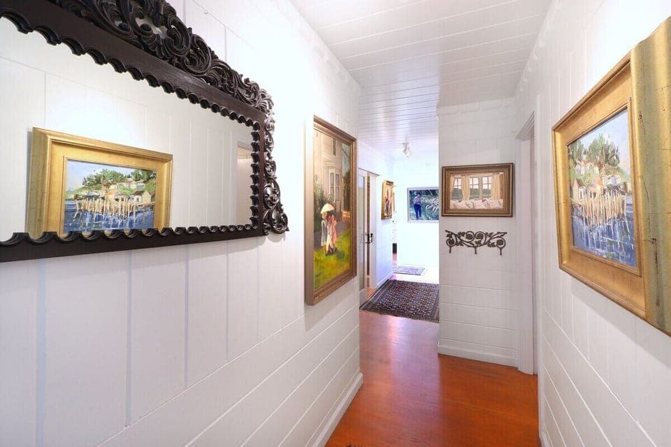 This is the view as you walk in the house although there are now new carpets to make it more comfortable. The kitchen and living room is to the immediate left. Three of the bedrooms and the bathrooms are down this hall. 