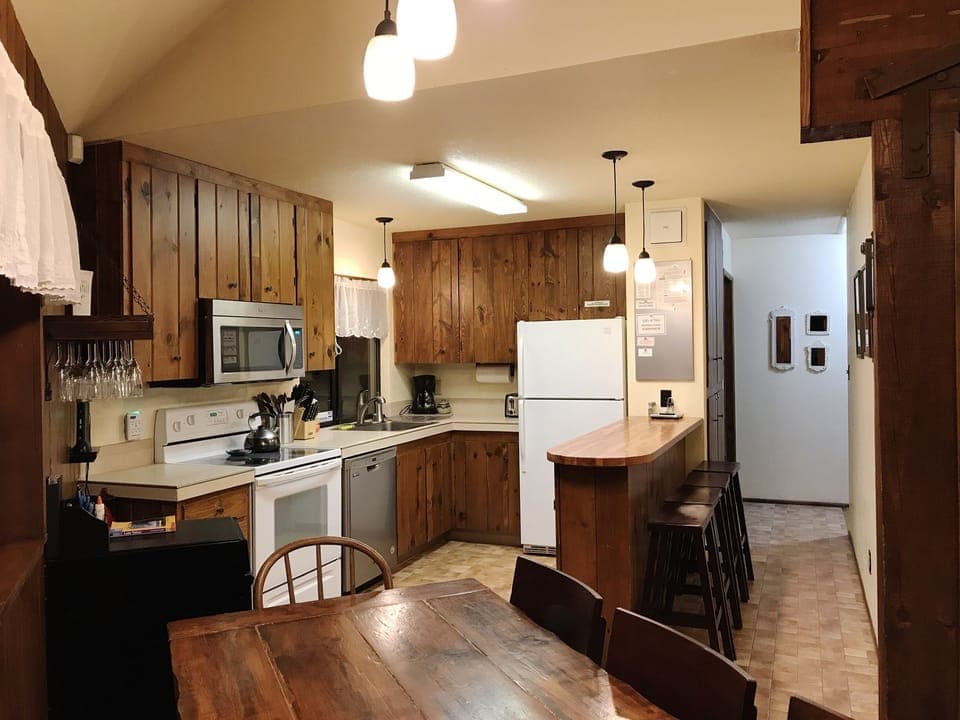 Open kitchen with adjacent counter creates a culinary and social atmosphere.