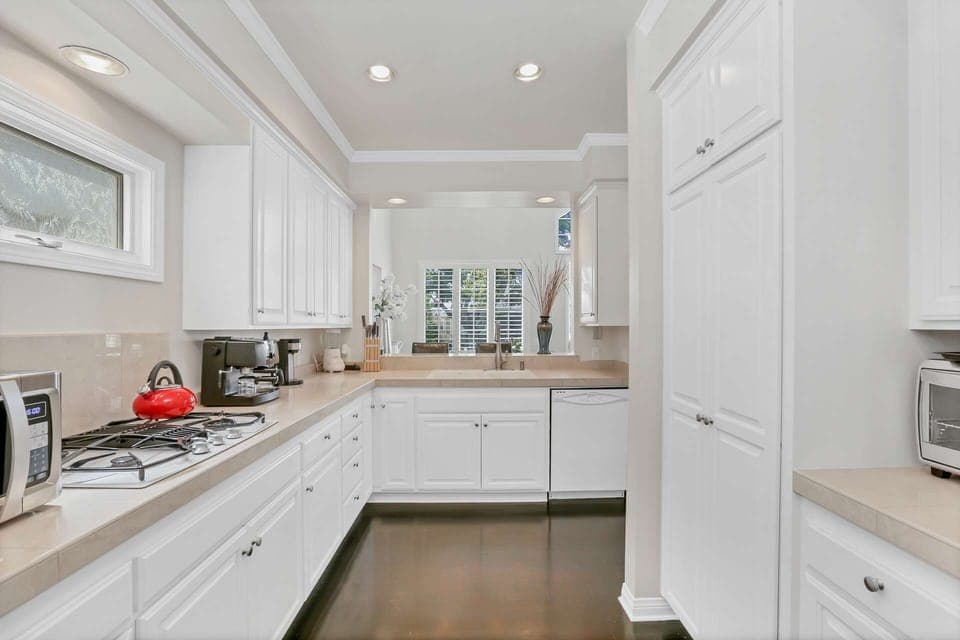 A spacious kitchen with high-end appliances is sure to please the chef in the family as they prepare a wonderful meal.