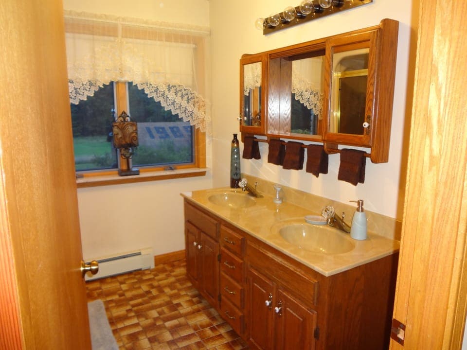 Upstairs bath has two sinks and a view.