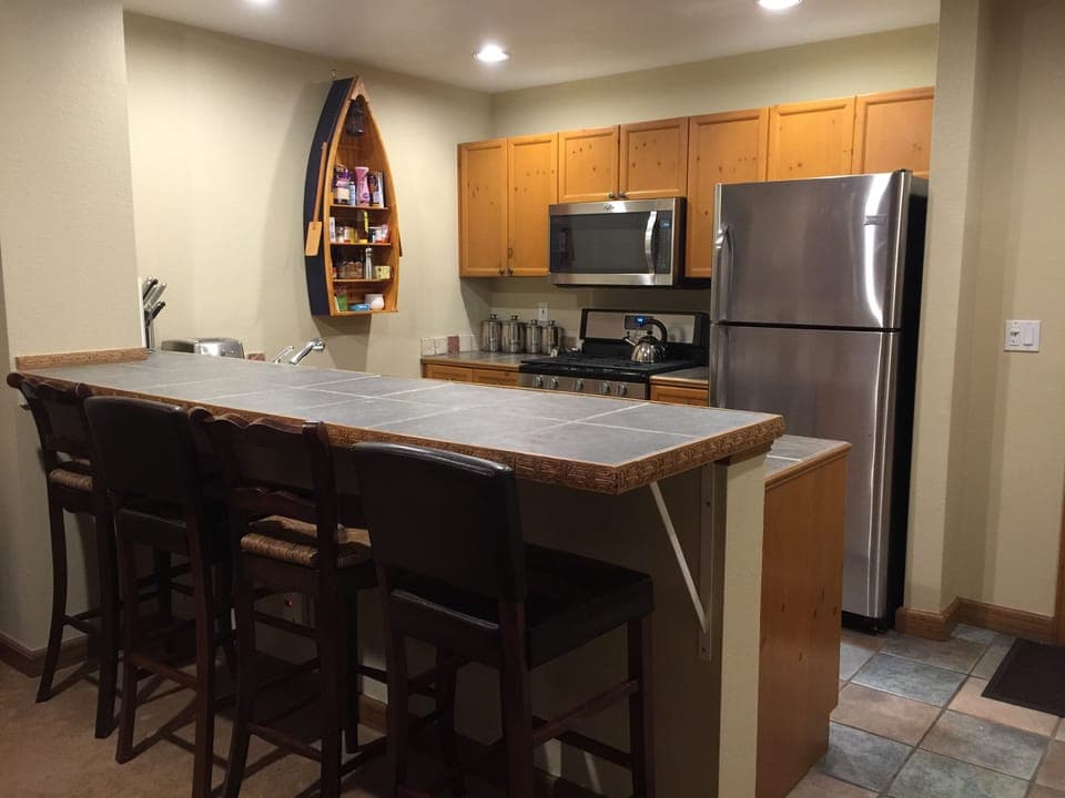 The kitchen has stainless steel appliances, all sorts of gadgets, coffee/creamer