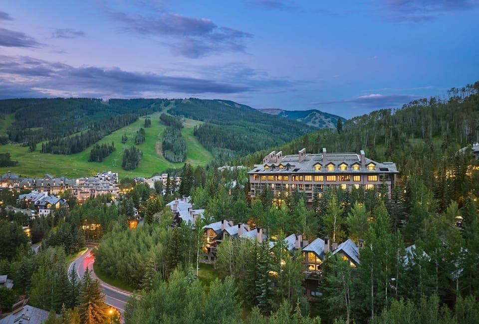 As evening falls, glow with warmth from the lodge, embraced by the stunning mountain backdrop.