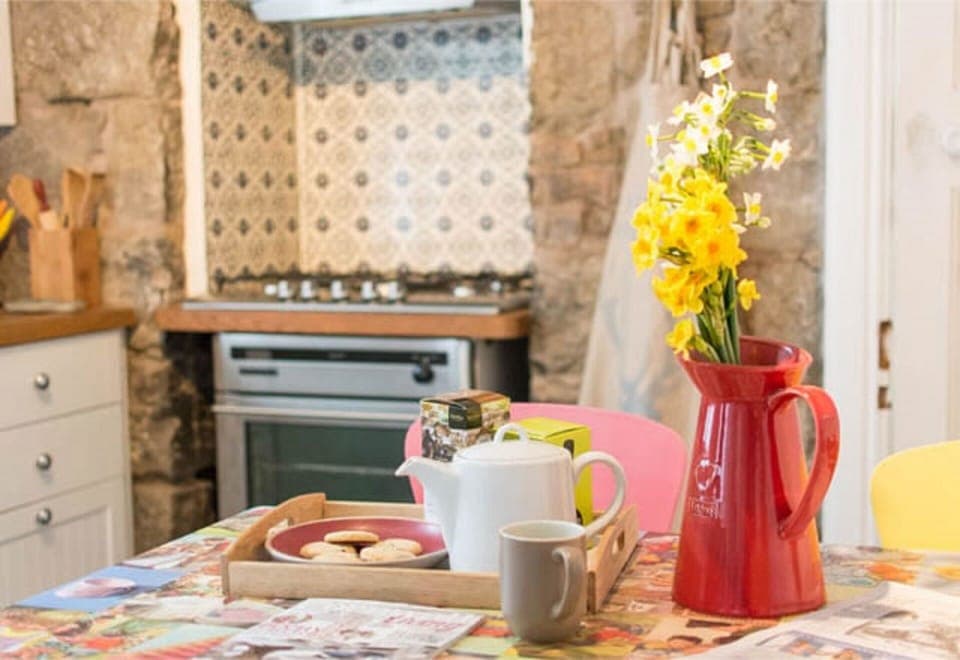 Cottage kitchen with original stone wall.