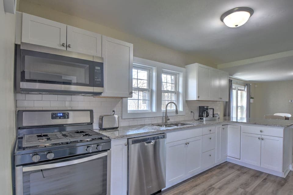 Large updated kitchen with full size stainless steel appliances and gorgeous cou