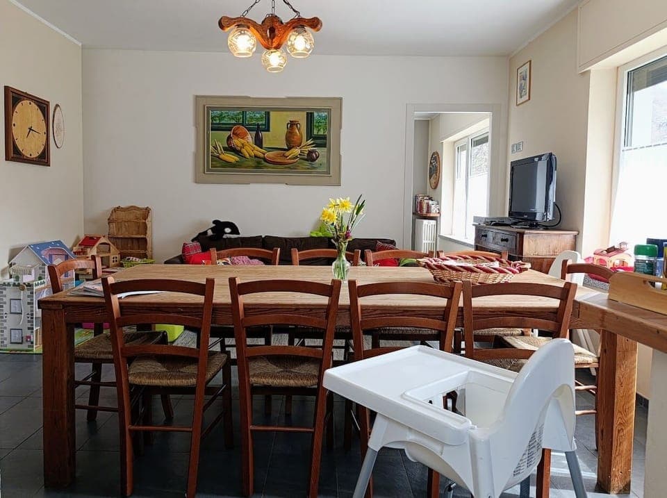 The wide wooden table in the living area. High chairs available on request!