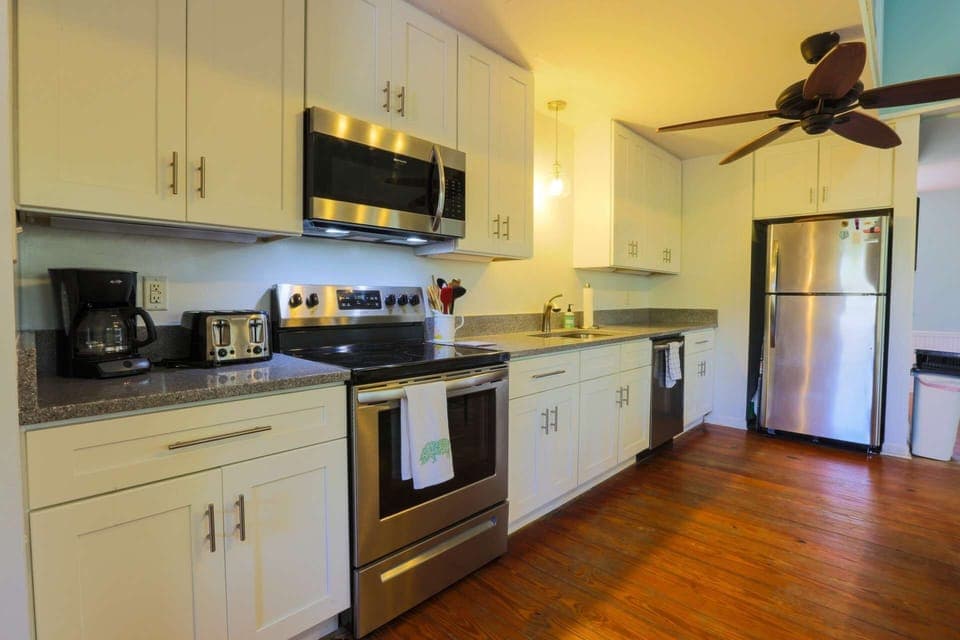 The newly renovated kitchen features new cabinets, new countertops and new lighting.
