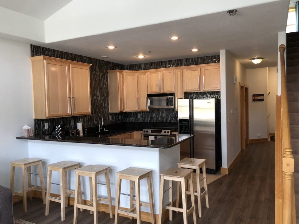View of the kitchen, with stools.