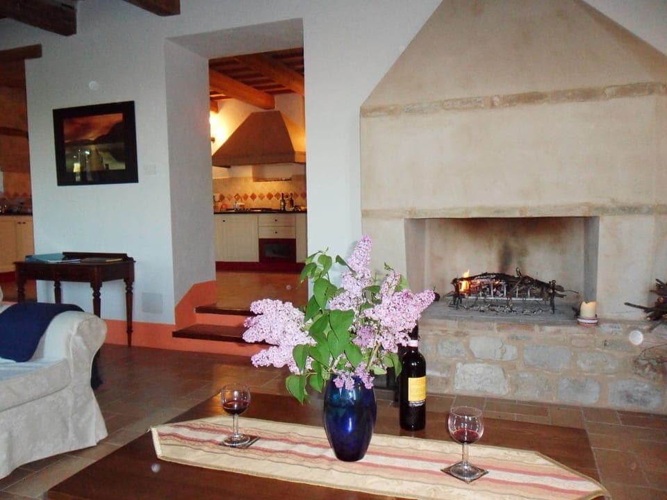 Traditional fireplace with kitchen beyond