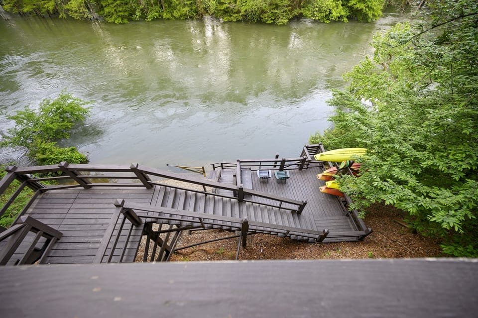 Welcome to Kingfisher with a deck leading the Mountain Fork River!