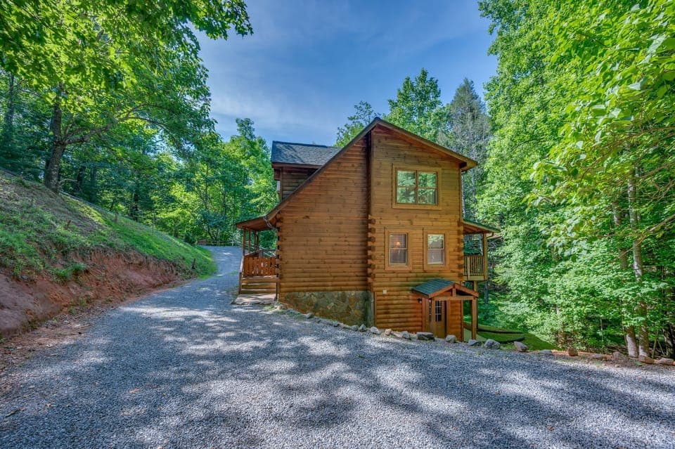Large 3 story log cabin in the mountains with hot tub and private Lake access.