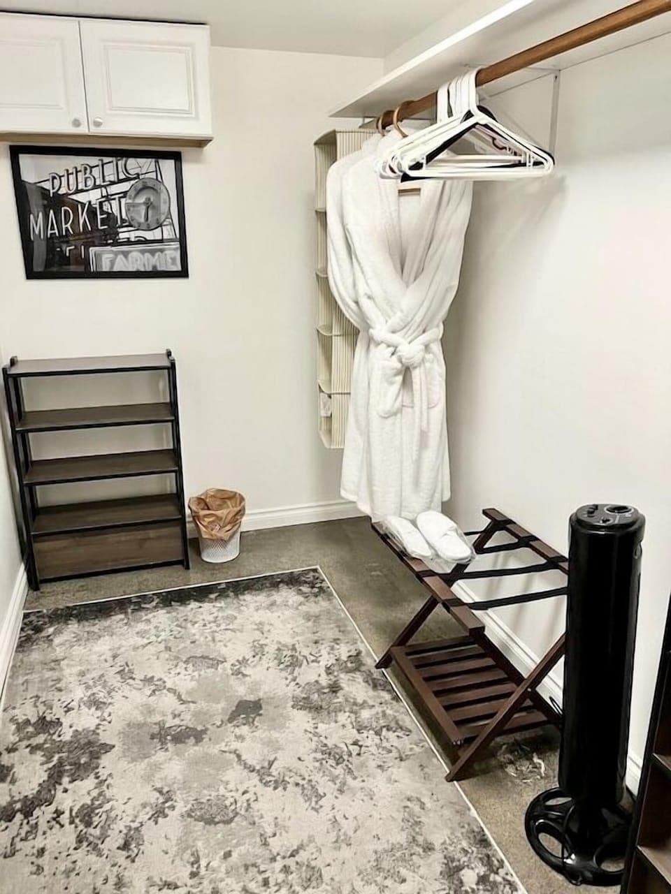 Huge walk in closet with storage and luggage rack