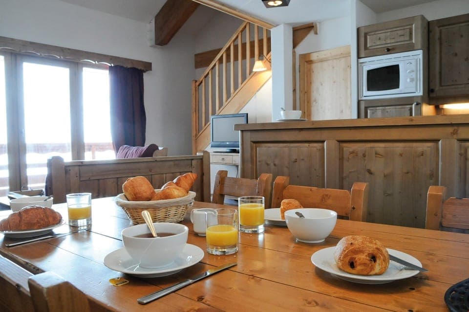 Prepare meals in the kitchenette and enjoy them at the dining table.