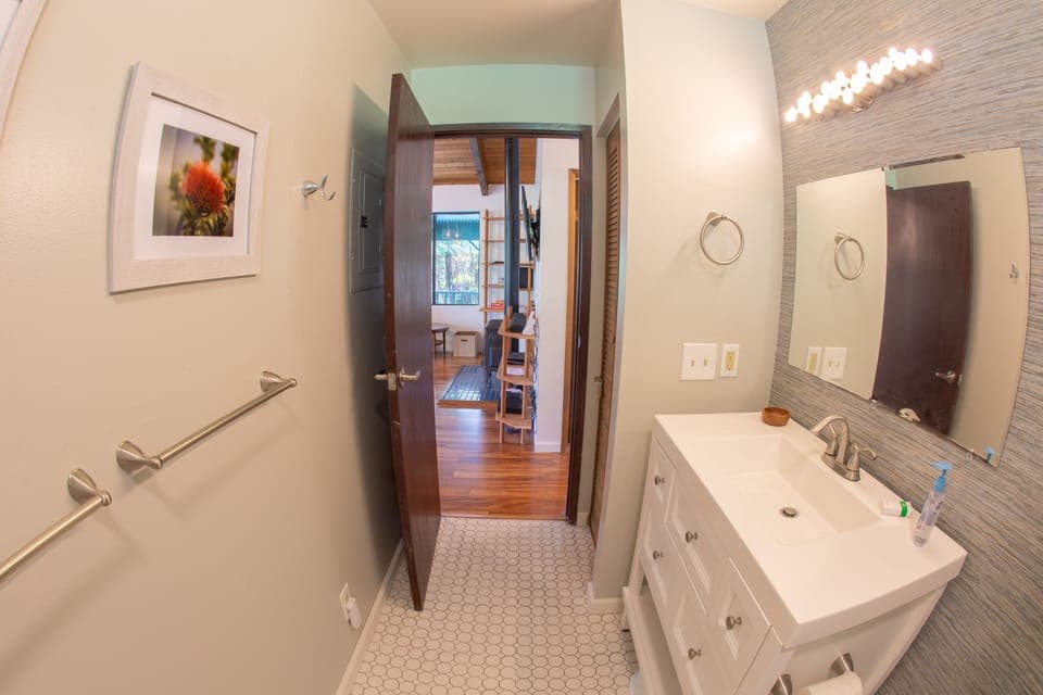 Bathroom is centrally placed between living are and bedrooms for accessibility
