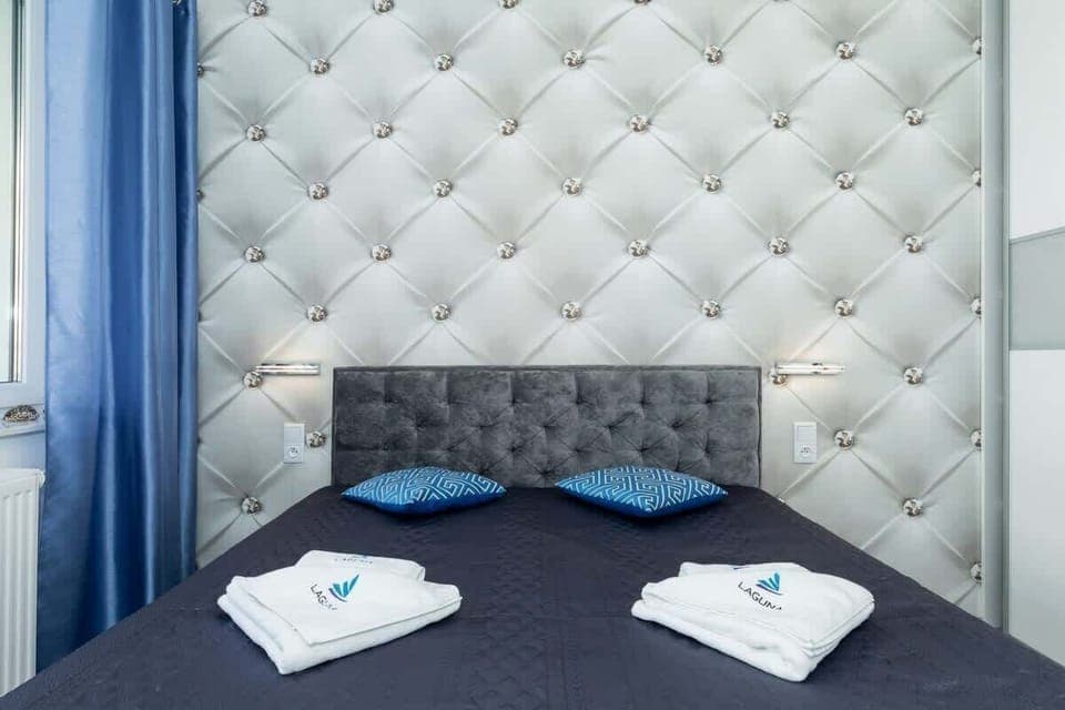 A bedroom with blue accents, soft bedding, and simple decor, providing a comfortable and peaceful environment.