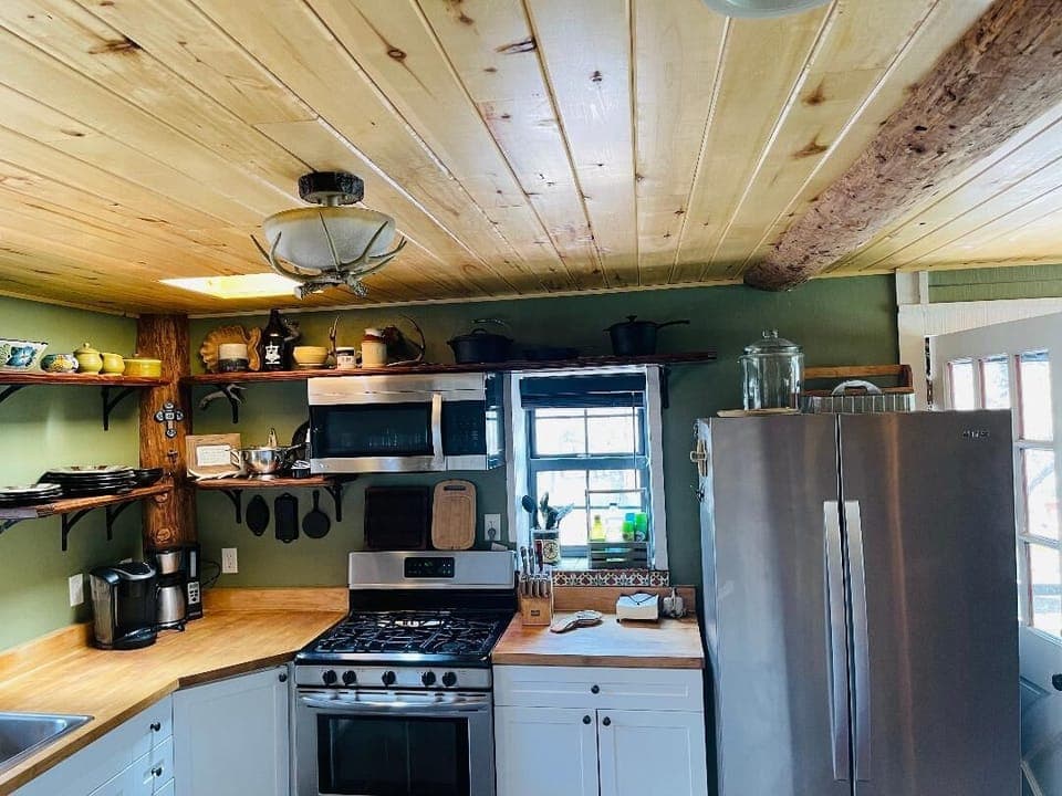 Aspen ceiling beams add character to the kitchen, open to the dining area.