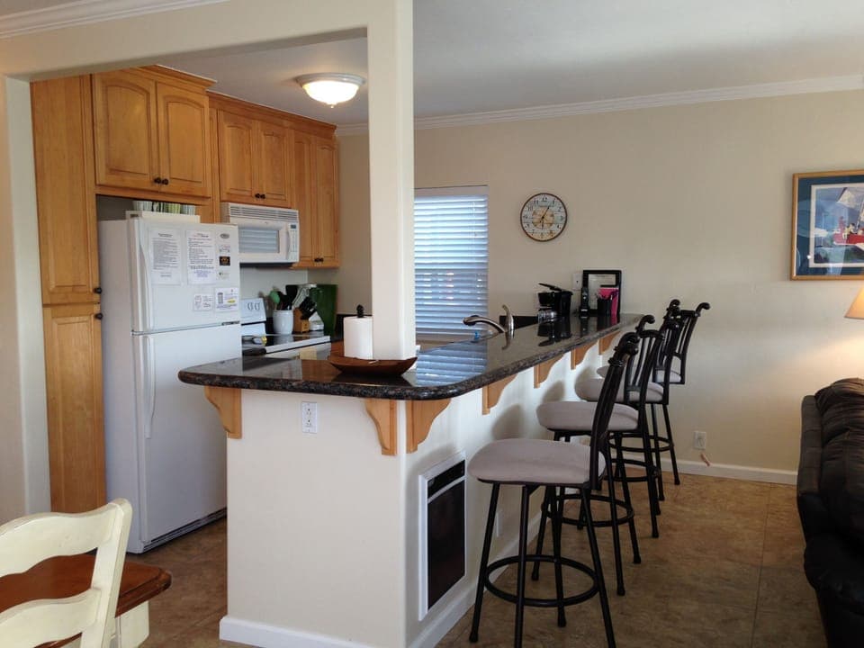 Fully stocked kitchen with bar seating for 4