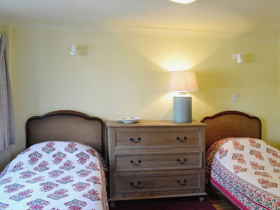 The twin bedded room is furnished with antique beds | Arkland Mill - Crofts Cottages, Near Castle Douglas