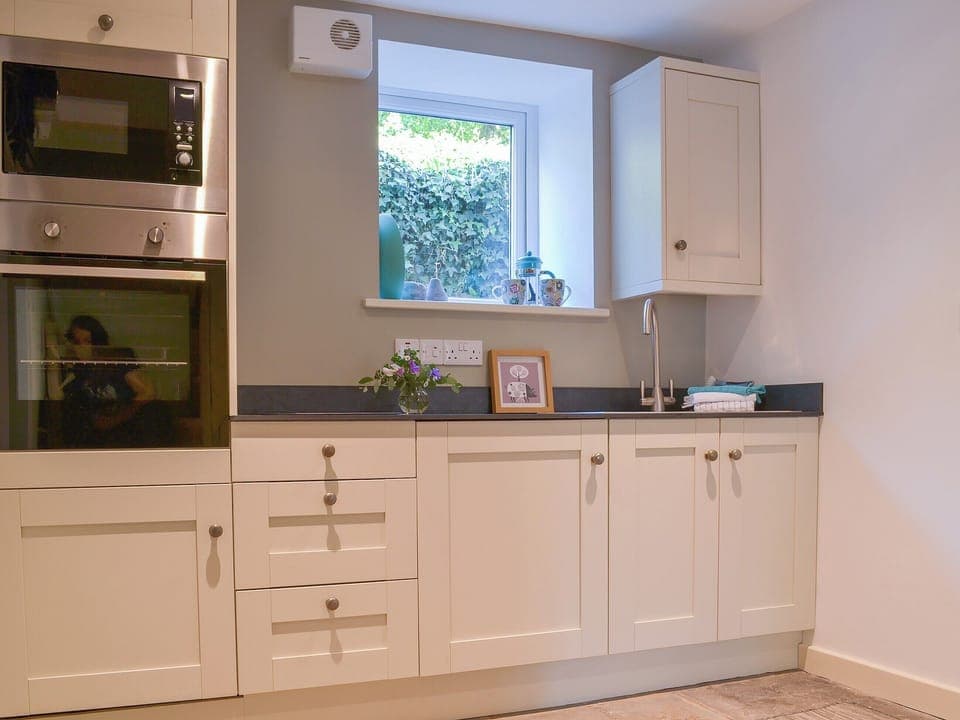 Stone-floored and beamed kitchen | Clarence Cottage, Appleby-in-Westmorland