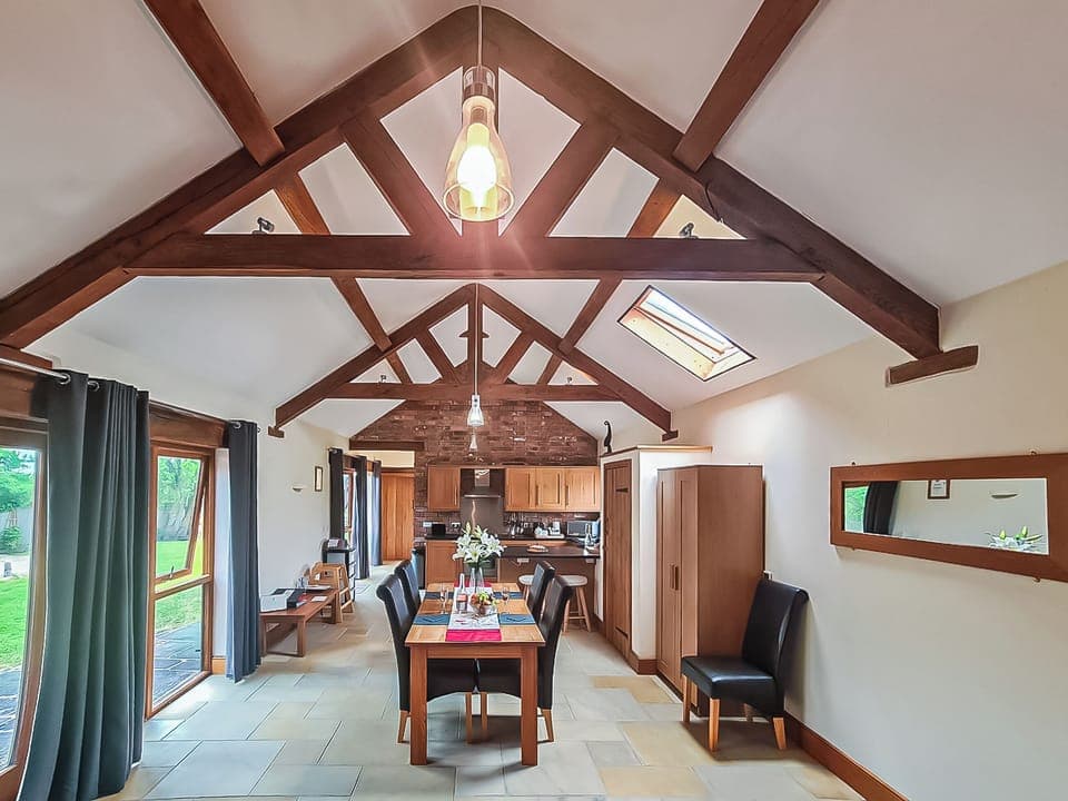 Open plan living/ kitchen/ dining room with original features such as traditional oak trusses | Blackberry Barn - Middle Huntingford Barns, Charfield, near Wotton-under-Edge