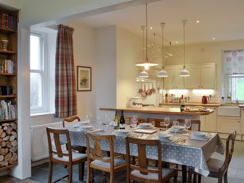 Large dining table in open plan room | Tyllwyd Farmhouse, Capel Bangor, near Aberystwyth