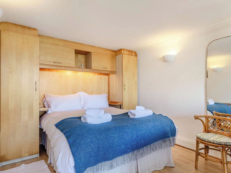 Comfortable double bed with built-in wardrobes for ample storage | Studio Sea Urchin, Carbis Bay, near St Ives