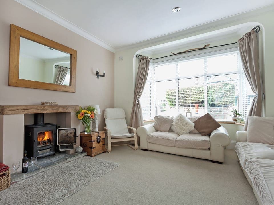 Beautifully designed living room with woodburner | Stourcliffe House, Bournemouth