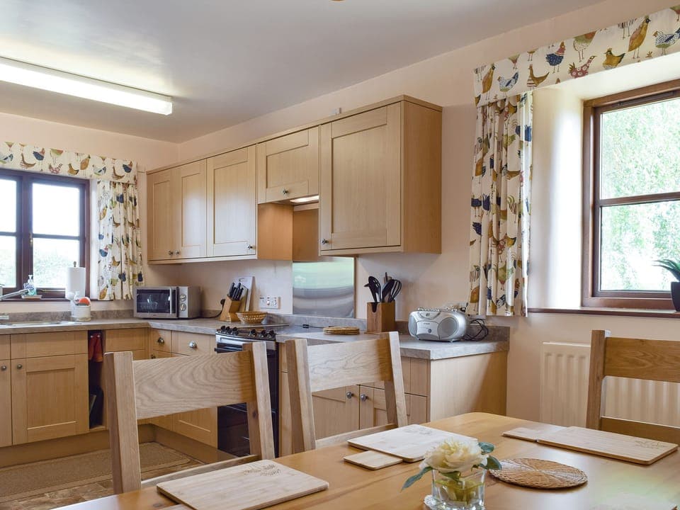 Convenient dining area within kitchen | Stildon Manor Cottage, Menith Wood