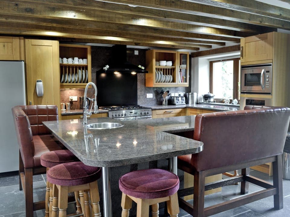 Well-equipped kitchen with breakfast bar | Kris Kin - Ymwlch Barns, Ymwlch, near Porthmadog