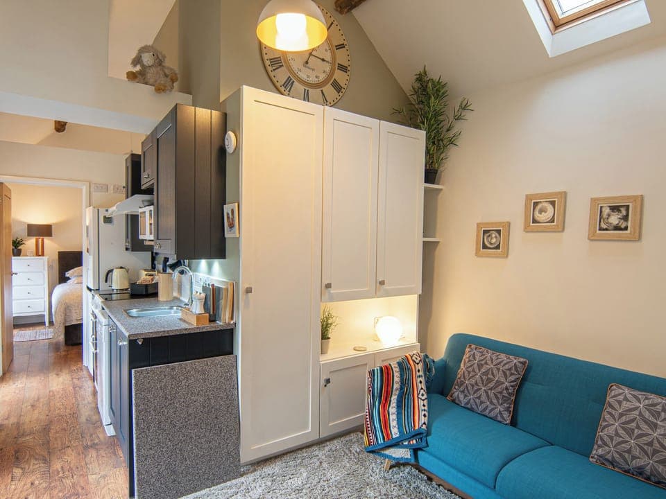 Bright and airy living room with high beamed ceilings, log burning stove and TV | Bailey&rsquo;s Barn, Bonsall, near Matlock