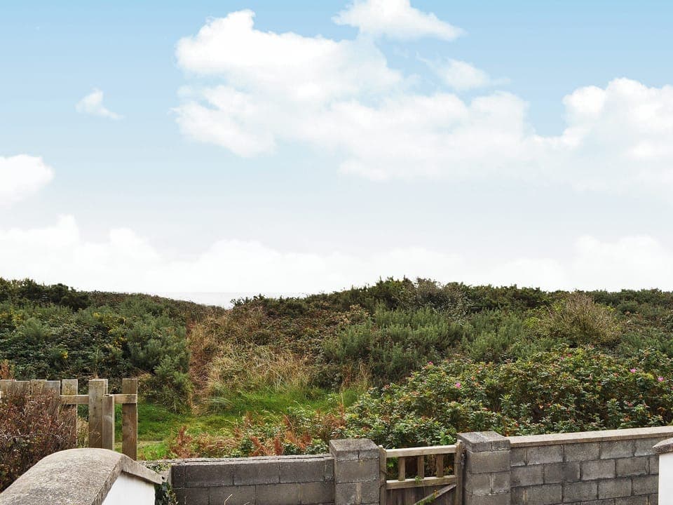 Sea view from the decked area with access to coastal path | Glan-Mor, Pwllheli