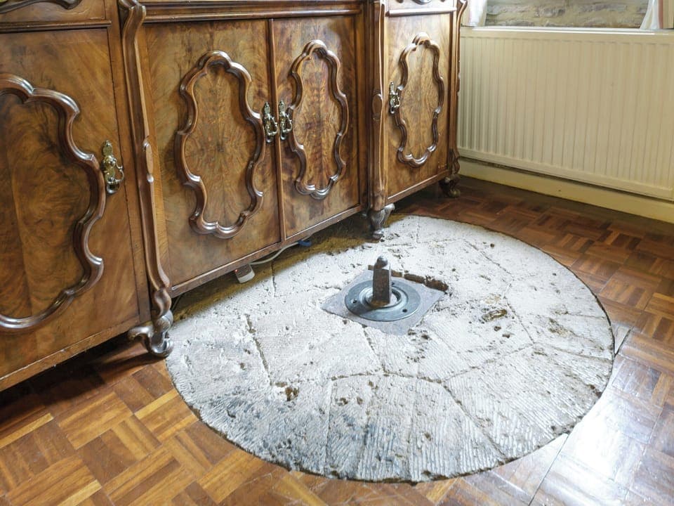 Original millstones in living room floor | The Mill House, Lea, near Ross-on-Wye