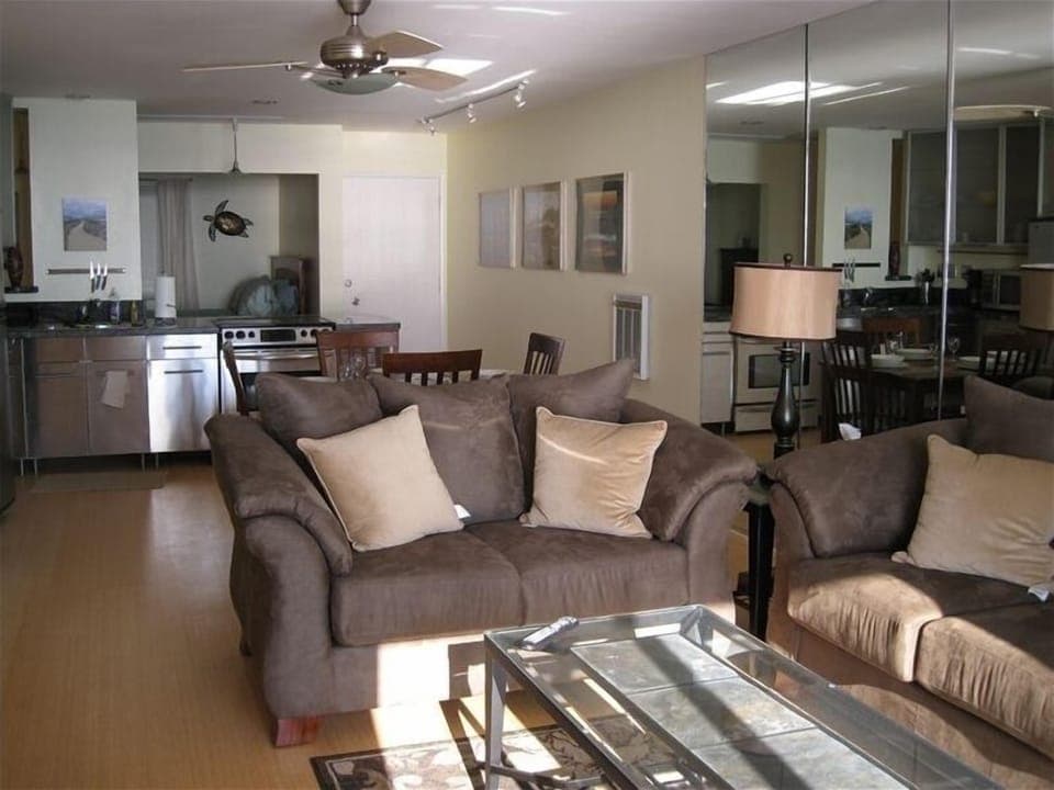Open floor plan with second bedroom in background.