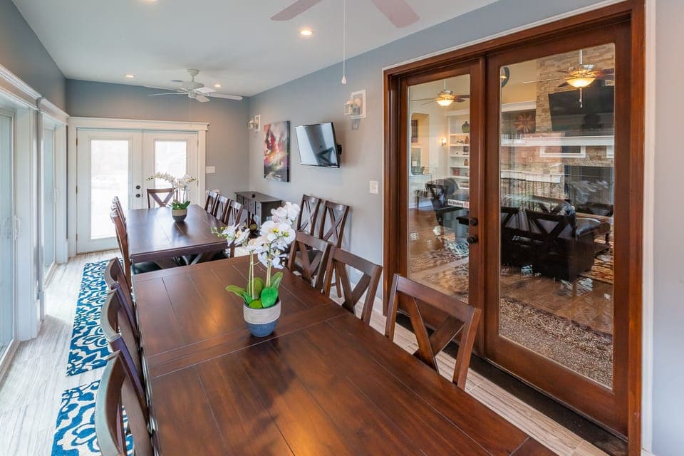 Bright beautiful dining room and sunroom seats 16
