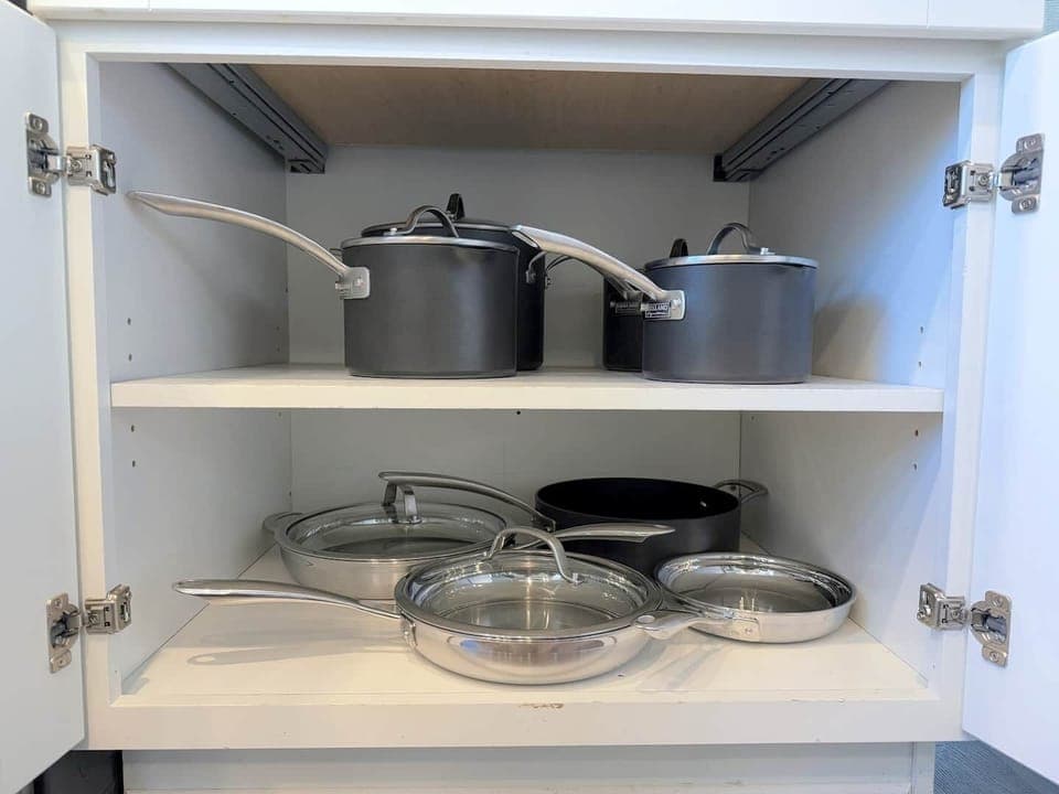 The kitchen is well stocked with cookware, utensils, silverware, and glassware. 