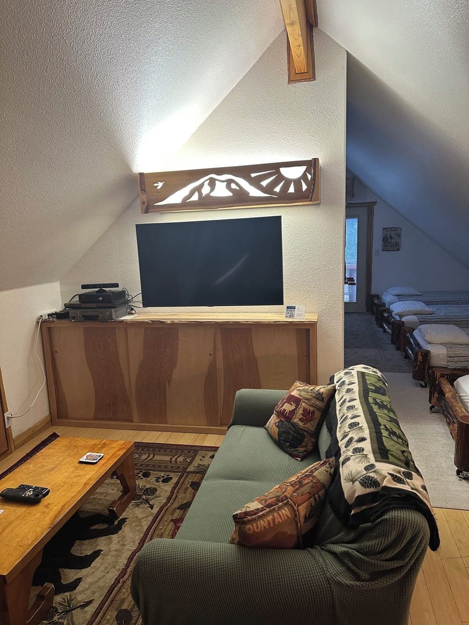 Loft TV area with DVD/VCR/Play station movies and games in storage cabinet.