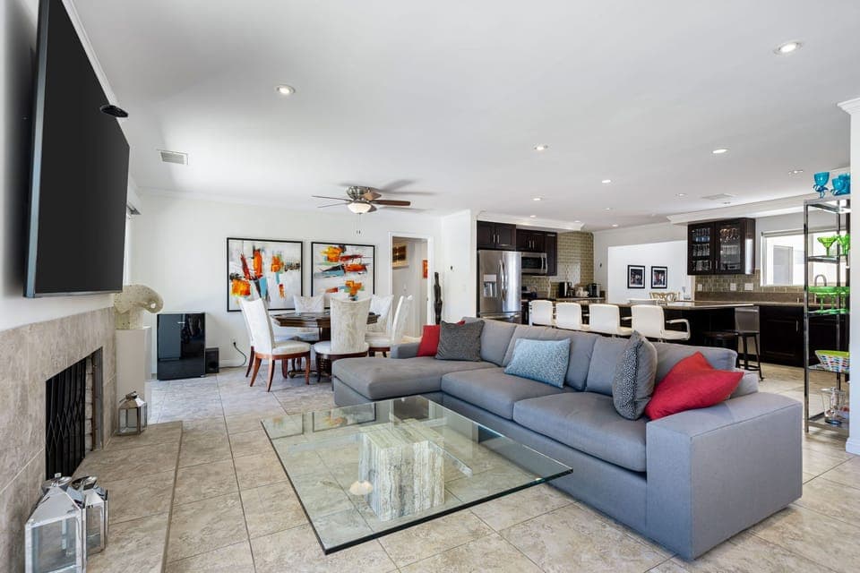 Living Room, sectional, 85 TV, Fireplace, poker table, ceiling lights, paintings