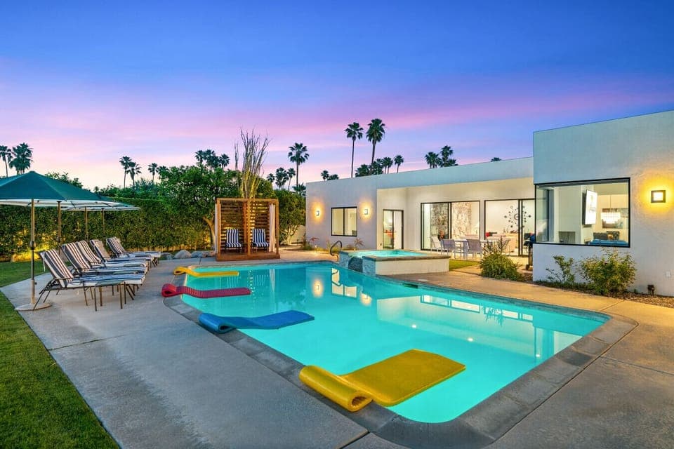Private desert wellness resort at twilight with pool, spa, and cabana under pastel Palm Springs skies