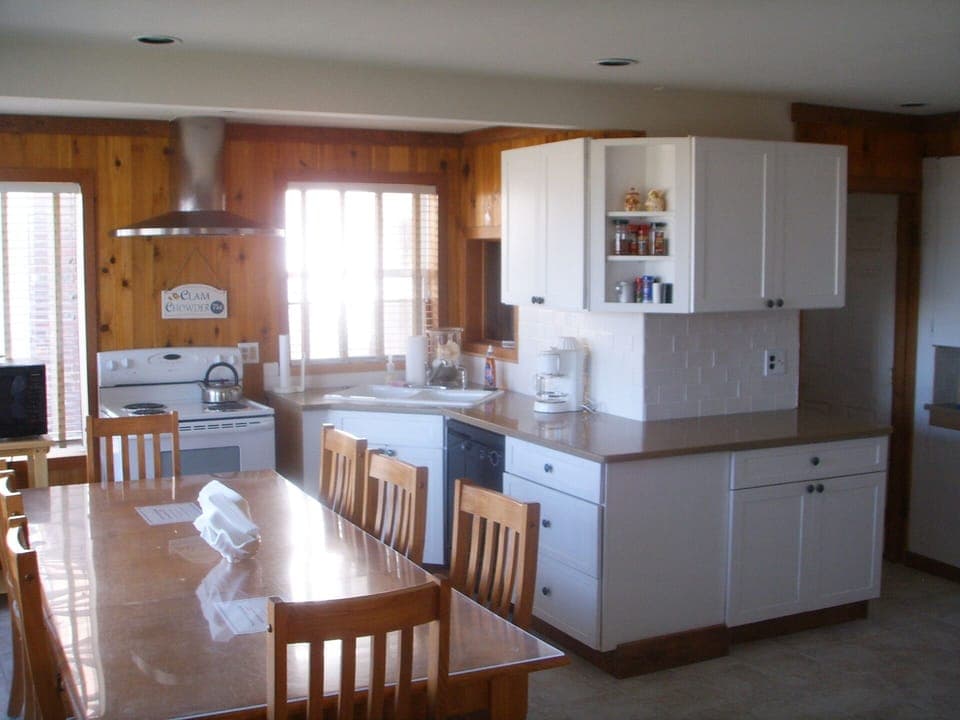 Kitchen with all utensils and seating for ten to twelve. Plenty of room for all.