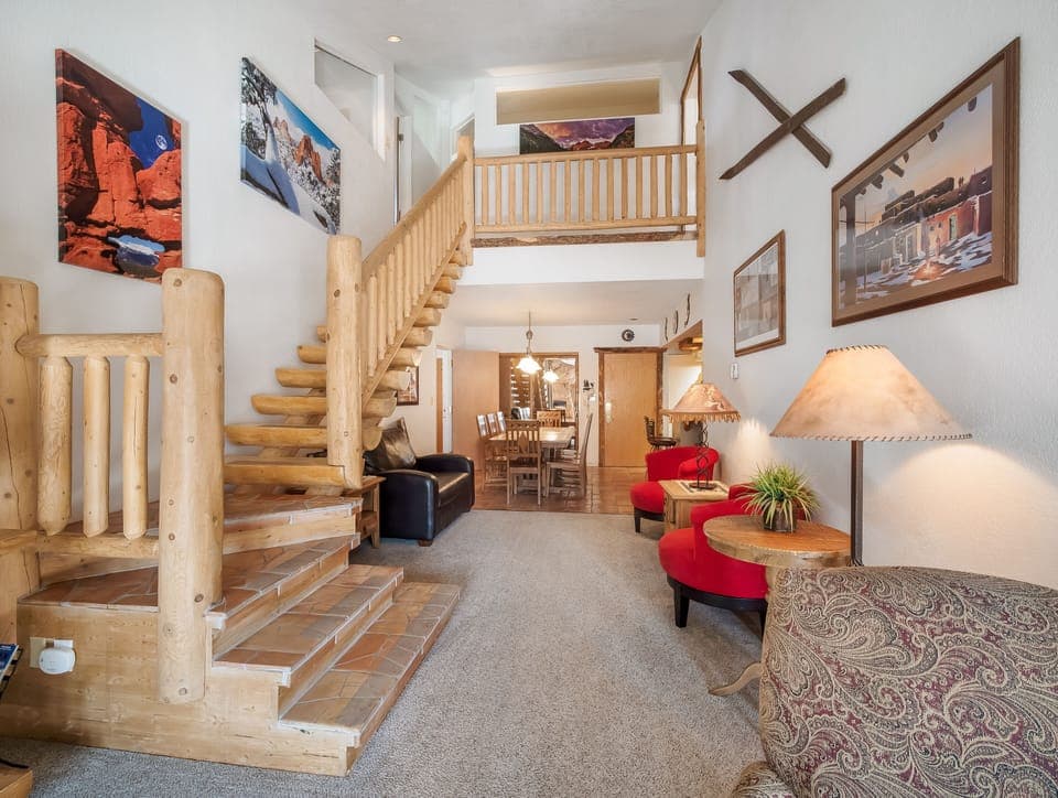 View from living room of stair case to second floor and dining room