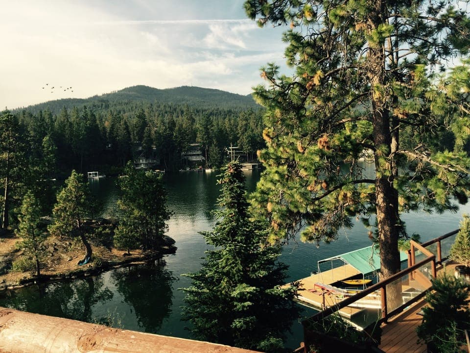 view from top deck includes island, mountains, dock area.