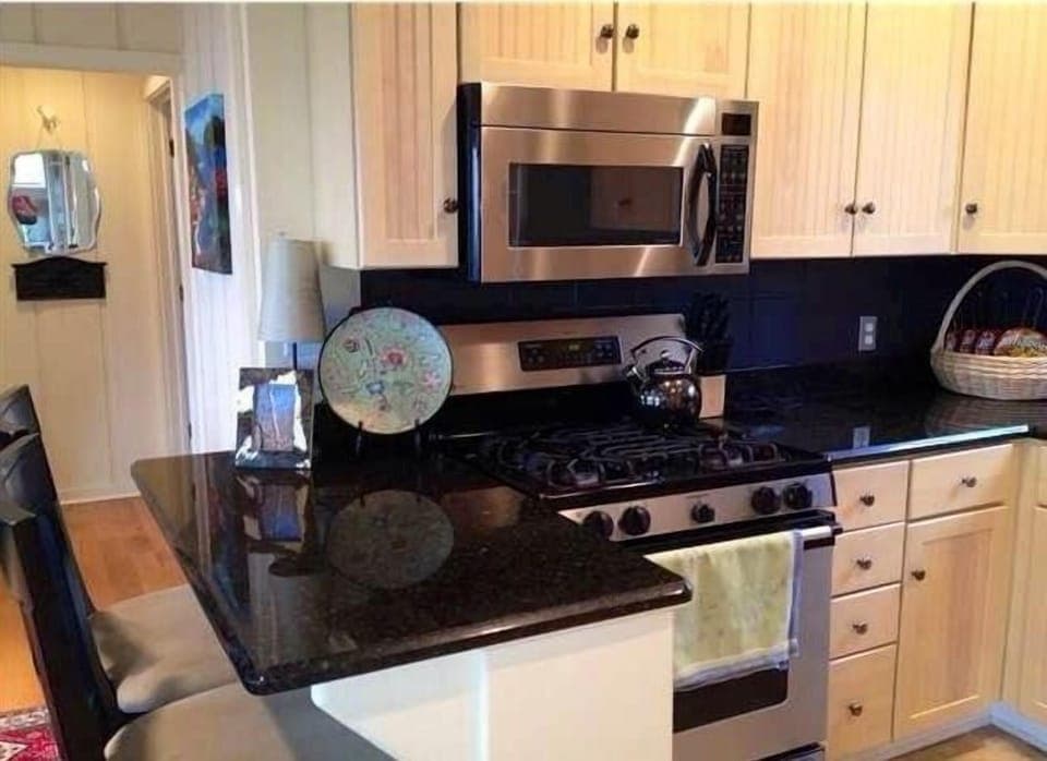 Stainless steel, gas range, and granite make this perfect for gourmet meals.