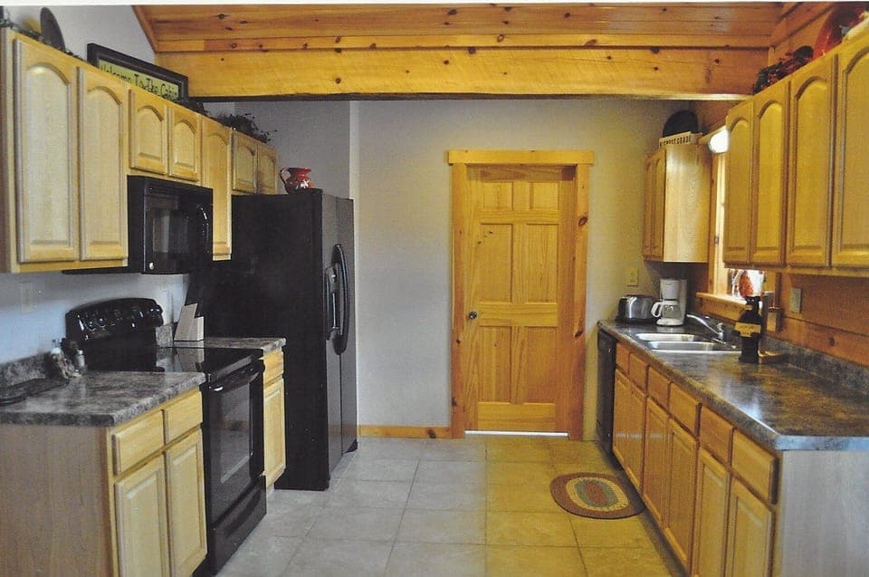 Kitchen area with laundry room through the door.