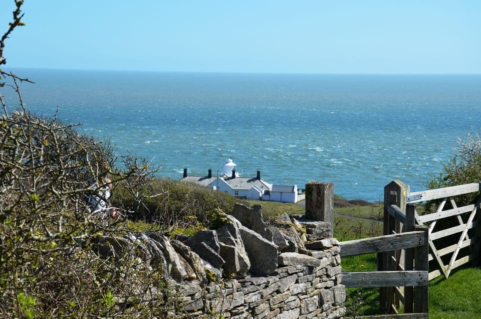 The gardens back onto Durlston Country Park. Anvil Point Lighthouse pictured.