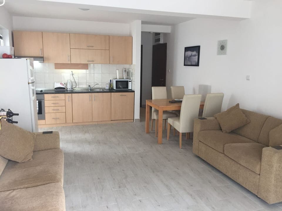 Large open plan living/dining area with two sofas