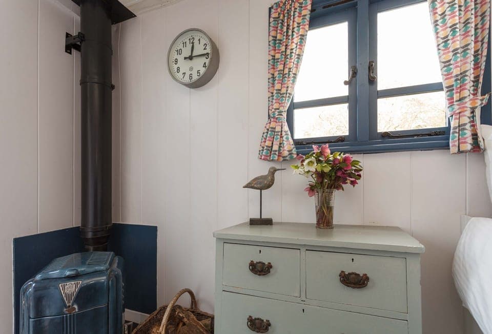 Plum Cottage: The wood burning stove, in the shepherds hut