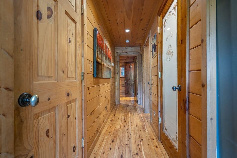 Hallway to main floor bedroom with laundry room and pantry.