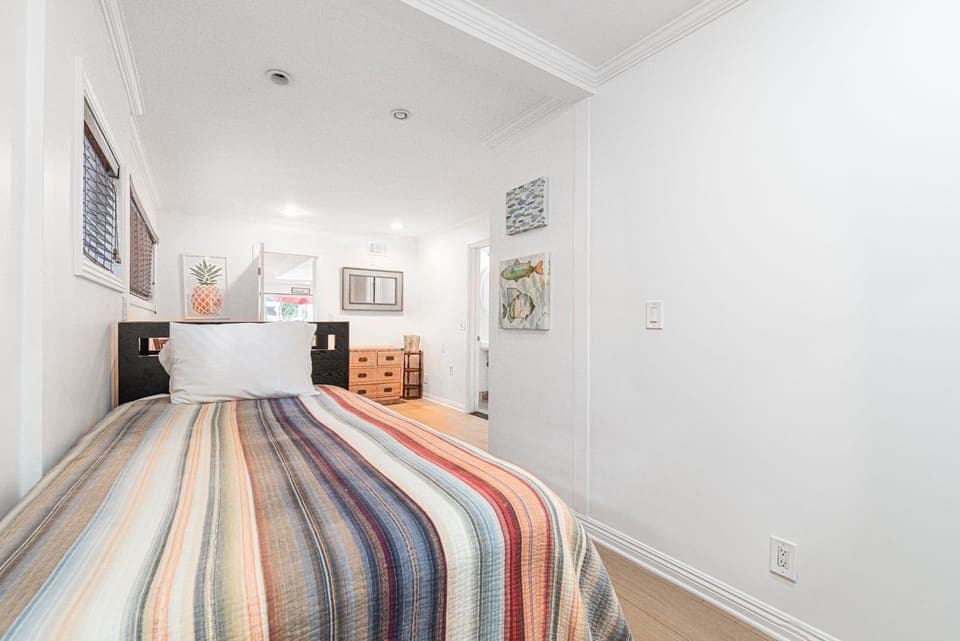 Bedroom #1 is located on the main floor and includes two twin beds, an en suite bathroom, and an access door to the garage.
                