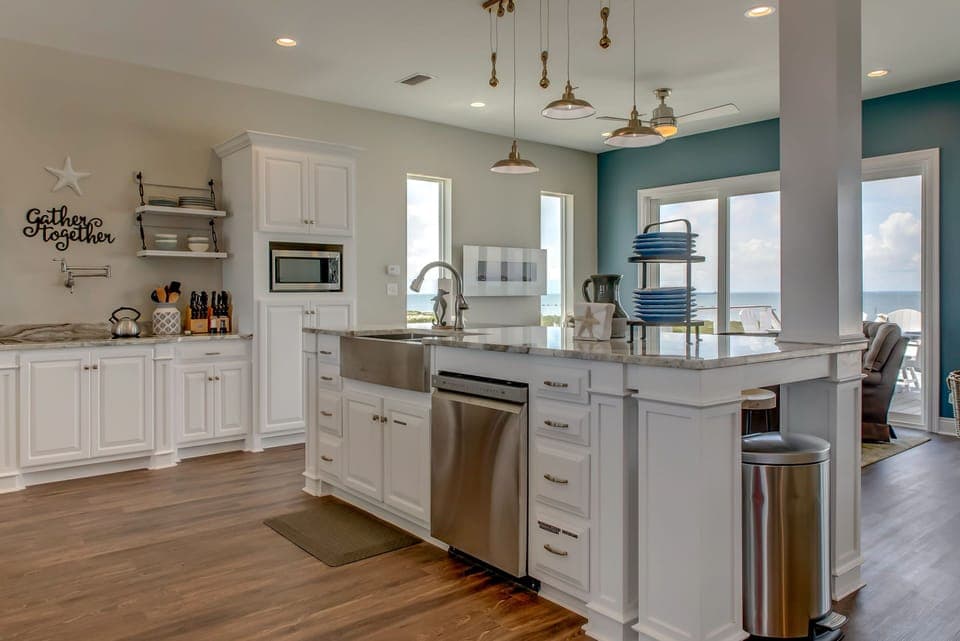 Your fully equipped kitchen welcomes you with ocean views, granite countertops, and modern appliances perfect for creating memorable meals together.