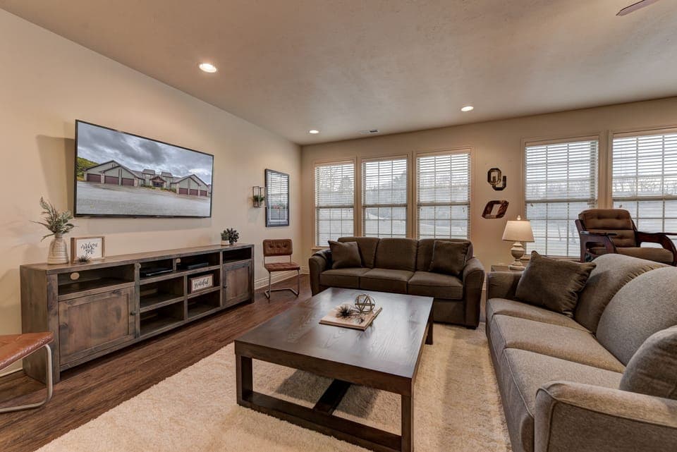 Comfortable couches with plenty of seating in front of the 65 in TV. 